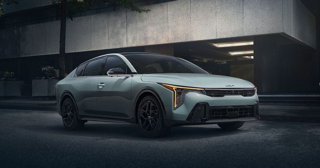 The 2025 Kia K4 compact sedan parked on a city street.