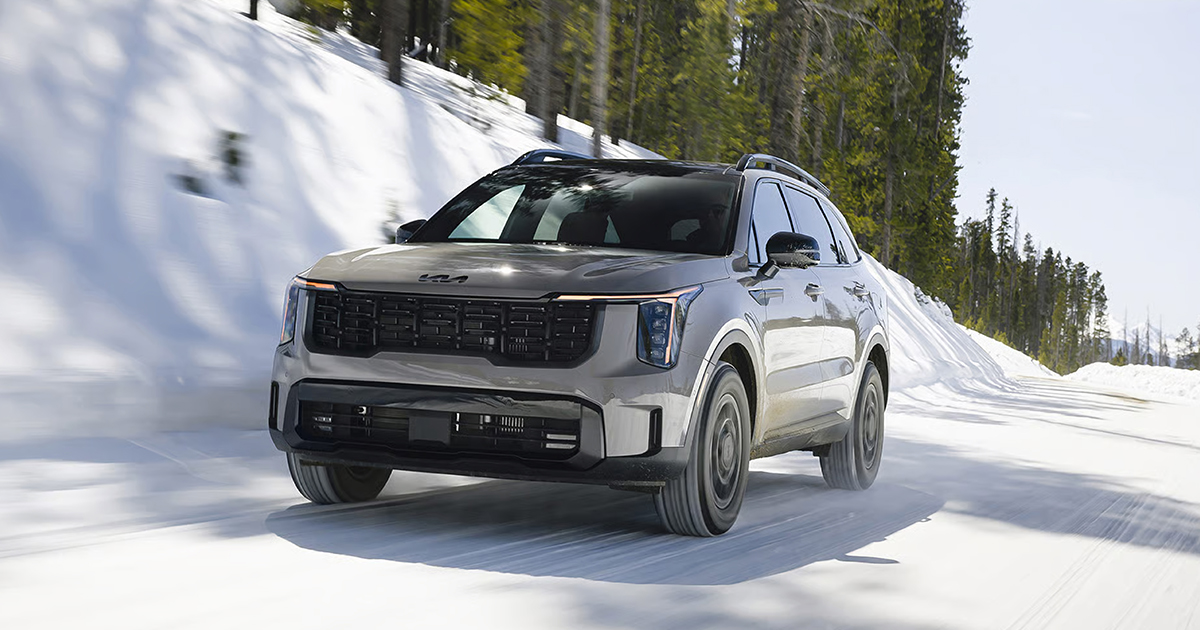 A Kia Sorento driving on a snowy road