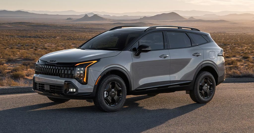 A 2026 Kia SUV on a mountainous landscape.
